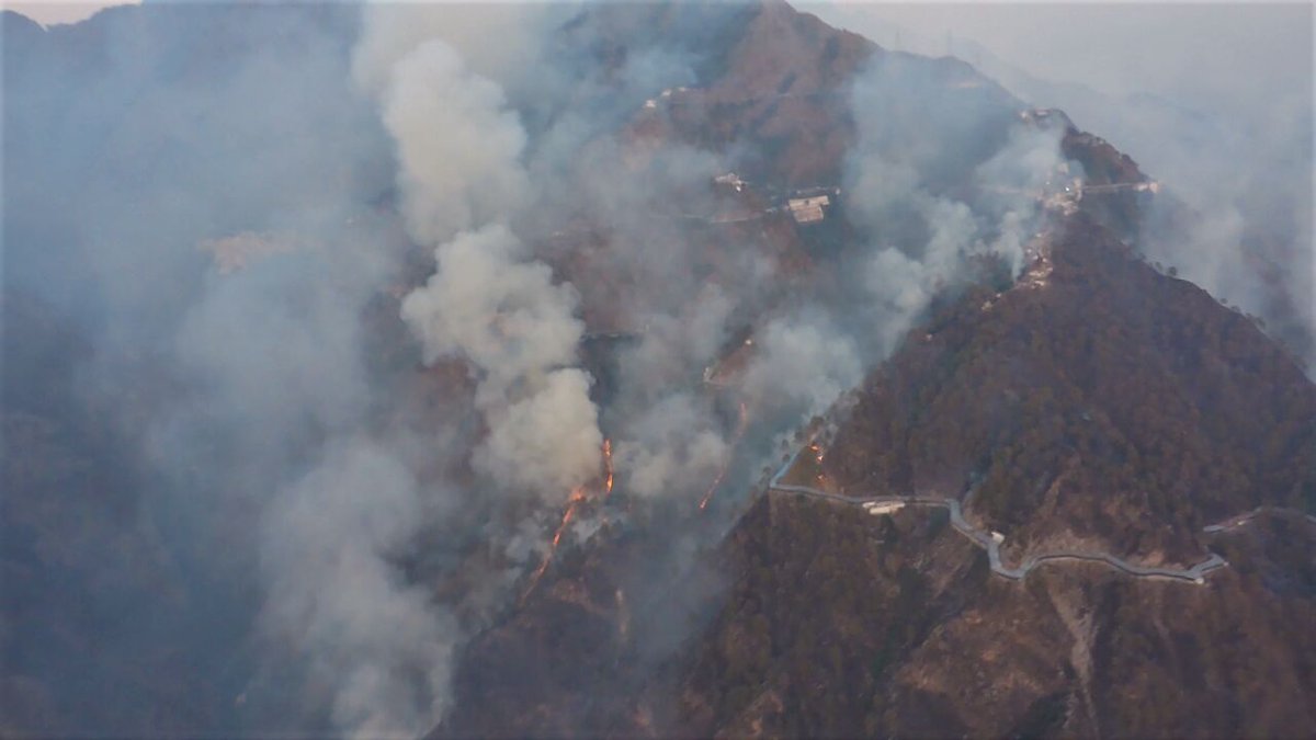 J&K: Fire that broke out in Trikuta Hills of Katra district continues to rage, Indian Air Force helicopters, with under-slung bambi bucket, deployed to douse the flames