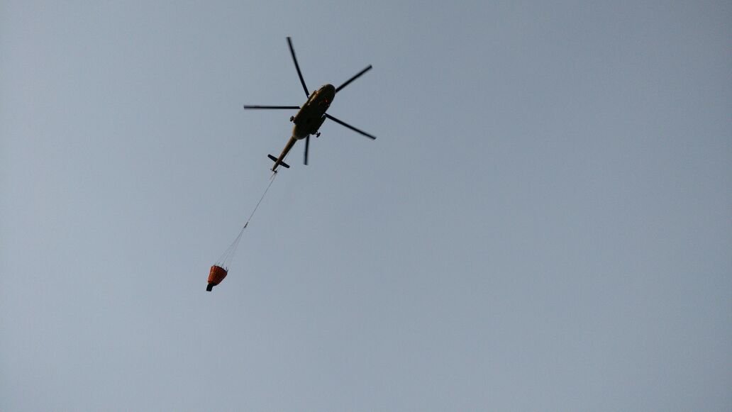 J&K: Fire that broke out in Trikuta Hills of Katra district continues to rage, Indian Air Force helicopters, with under-slung bambi bucket, deployed to douse the flames