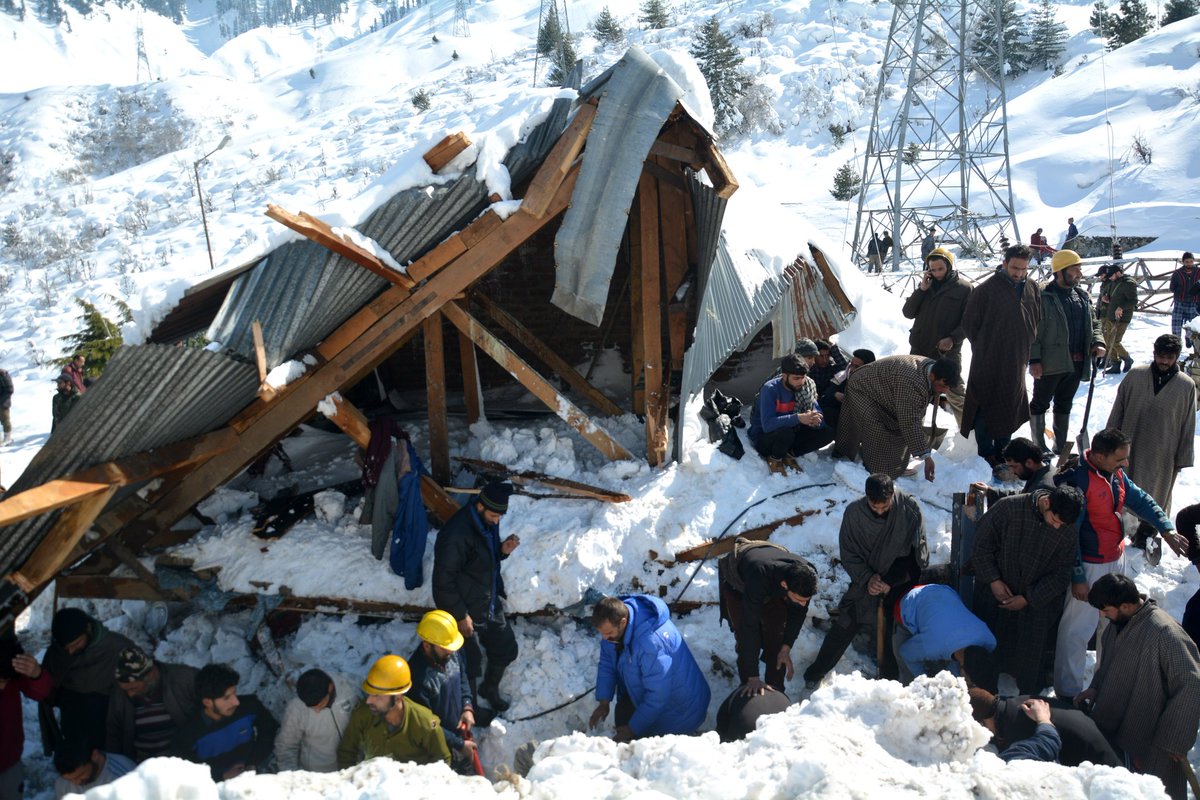 Rescuers search for survivors after a snow avalanche buried a police post near Jawahar Tunnel in Kulgam district of Jammu and Kashmir on Friday.  
