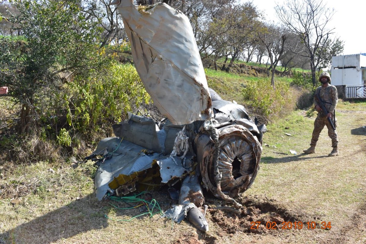 Pakistan army releases images of a downed Indian jet and documents/guns recovered from the captured pilots.   