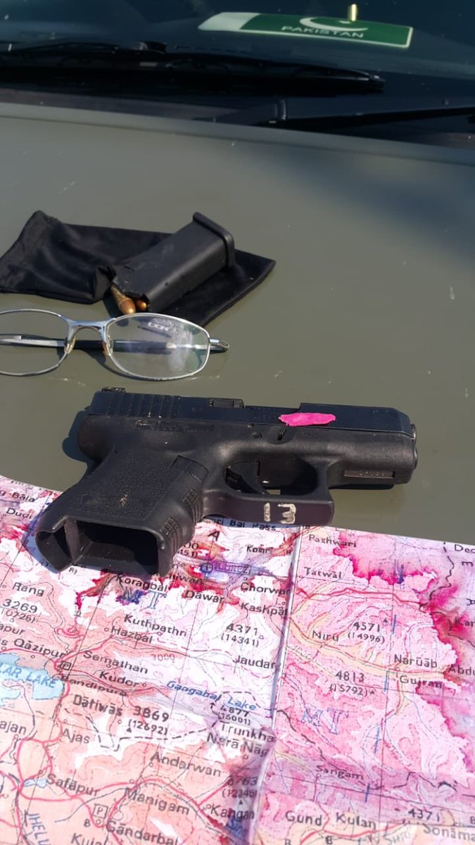 Pakistan army releases images of a downed Indian jet and documents/guns recovered from the captured pilots.   