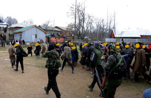 Jaish-e-Mohammed (JeM) militants leaving the funeral ground after giving a gun salute to two slain JeM militants killed in Shopian, India-held Kashmir 